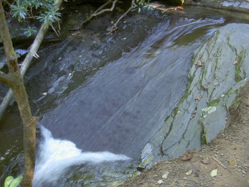 Water smoothly sliding down a 6ft section of rock right before the falls