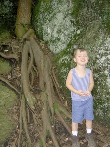 Ben beside a root from a tree hanging onto the cliffside for dear life.