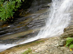 The water immediately enters a thin channel carved in the rock no more than a couple feet wide.