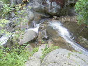 The water exits that channel into a small pool before continuing on down over more small cascades and falls.