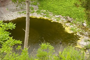 See the fisherman in the pool at the base