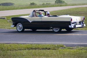 Lots of classic cars heading through the area, some kind of 